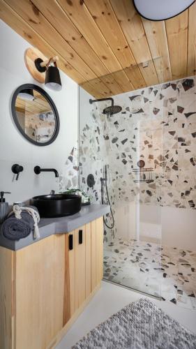 a bathroom with a sink and a shower at Kabinka Mátra in Pásztó