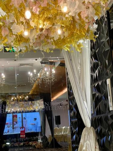 a room with a chandelier and flowers on the ceiling at Empyrean Dhaka City Centre in Dhaka