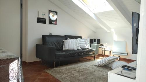 a black leather couch in a living room at Casa Marcone in Deiva Marina