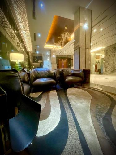 a lobby with couches and chairs in a room at Empyrean Dhaka City Centre in Dhaka