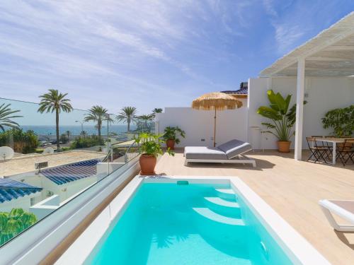 a villa with a swimming pool and a patio at Pasitoblanco Porto Mare 44 Seaview Villa private heated pool in Pasito Blanco