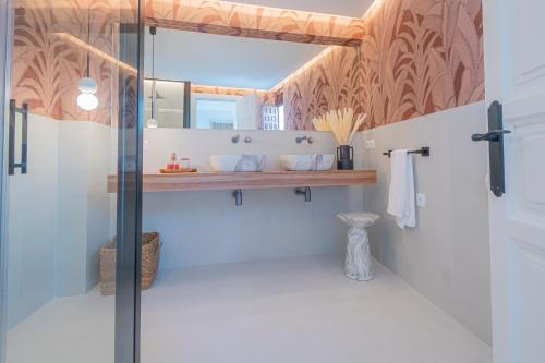 a bathroom with a glass shower with a mirror at Casa de la Acequia by Florentia Homes in Granada