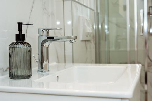 a bathroom sink with a soap dispenser on a counter at villa Ana in Preko