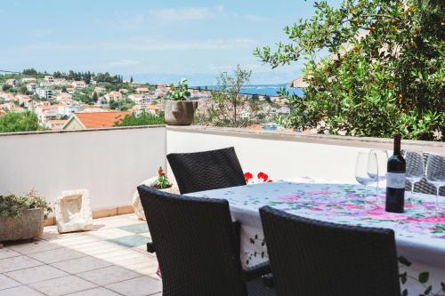 a table and chairs on a patio with a view at villa Ana in Preko