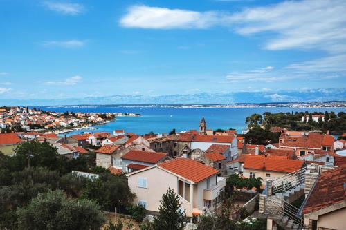 a city with a view of the water and buildings at villa Ana in Preko