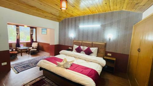 a bedroom with a large bed in a room at Hotel Hilltop At Mall Road Manali With Open Terrace in Manāli