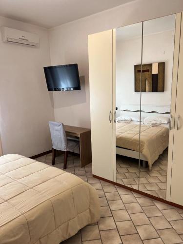 a bedroom with a mirror and a bed and a desk at Villa Gianna in Taranto