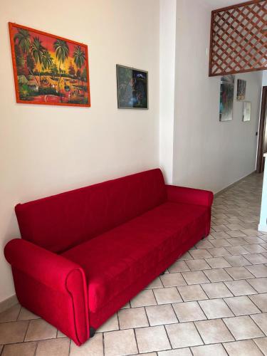 a red couch sitting in a living room at Villa Gianna in Taranto