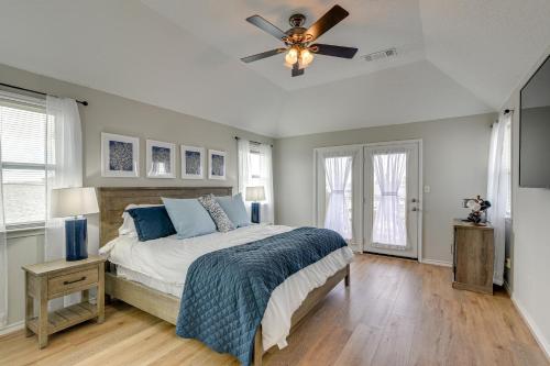 a bedroom with a bed and a ceiling fan at Bayfront Jamaica Beach House Canal Access and Decks in Galveston