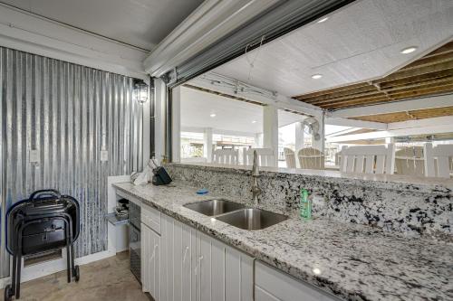 a kitchen with a sink and a counter top at Bayfront Jamaica Beach House Canal Access and Decks in Galveston