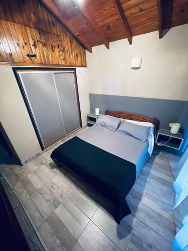 1 dormitorio con 1 cama grande en una habitación en El Caldén, Mar Blau a 1 cuadra del mar en Balneario Mar Azul