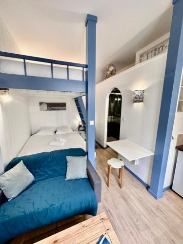 - une chambre avec des lits superposés et un canapé bleu dans l'établissement Le Piccolo, Centre-ville, à Bordeaux