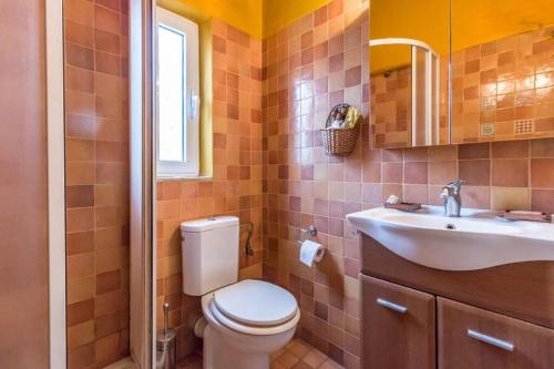 a bathroom with a toilet and a sink at Nano's House in Kala Nera