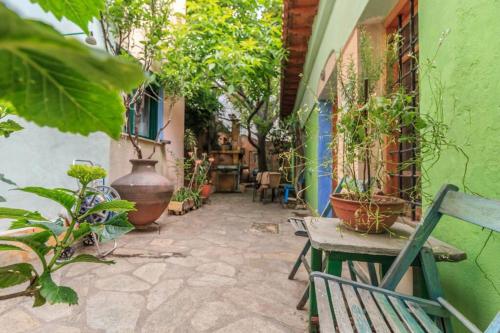 an outdoor patio with chairs and potted plants at Nano's House in Kala Nera