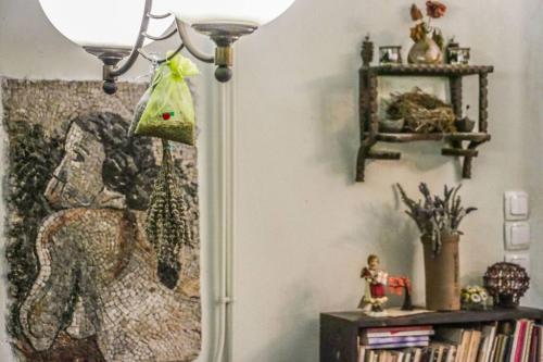 a lamp in a room with a picture on the wall at Nano's House in Kala Nera