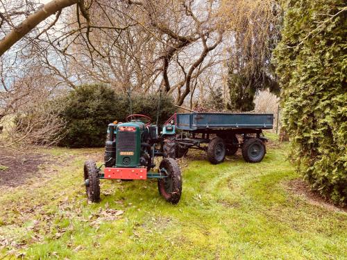 a tractor and a dump truck in a field at Spurensucher Quartier in Usedom Town