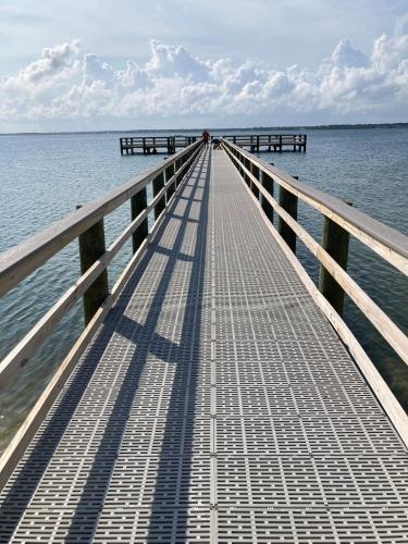 a long pier stretches out into the water at Romantic condo for 2-Sunset Harbor Palms 1-205, pool, fishing pier in Navarre