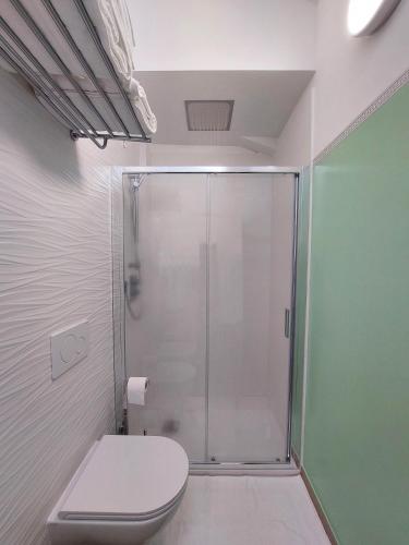 a bathroom with a toilet and a glass shower at Affittacamere Casa Lilibet in San Benedetto del Tronto