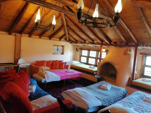 a living room with a couch and a fireplace at Large Stone Villa with garden. in Khánia