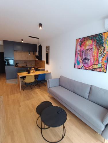 a living room with a couch and a table at Tesla Point in Osijek