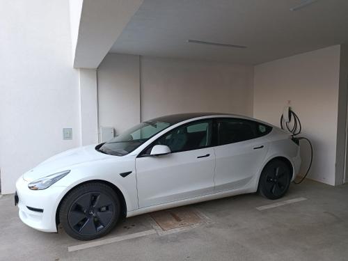 a white car is parked in a garage at Tesla Point in Osijek