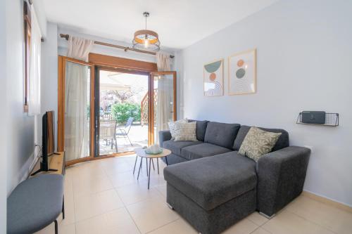 a living room with a couch and a table at khouse - Personal Paradise in Neos Marmaras