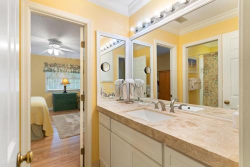 a bathroom with a sink and a large mirror at Village Walk - 104 Mews Circle in King City