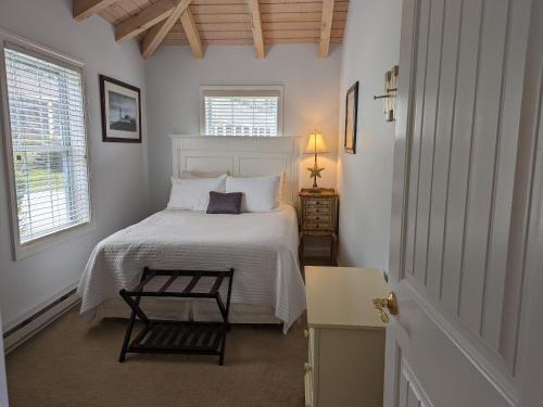 a bedroom with a bed and a table and a window at Riverview cottage in Edgecomb Sheepscot Harbour Vacation Club Cottage #19 in Edgecomb