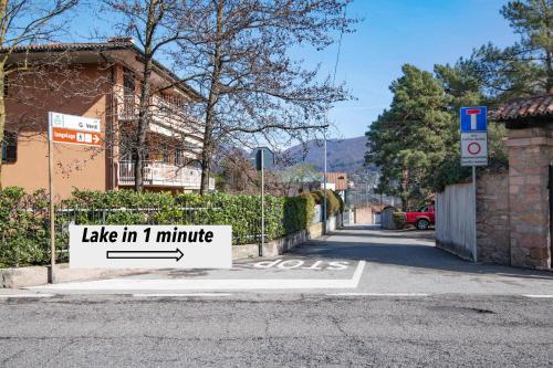 a sign that says take in minute on a street at ZARA HOUSE - Lake and Pet Friendly in Brusimpiano