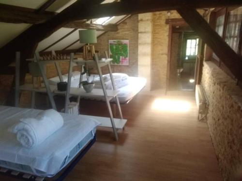 a room with two bunk beds in a attic at Petite maison de caractère in Le Bousquet