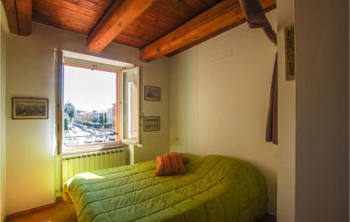a bedroom with a green bed and a window at Gorgeous Apartment In Fano With Wifi in Fano