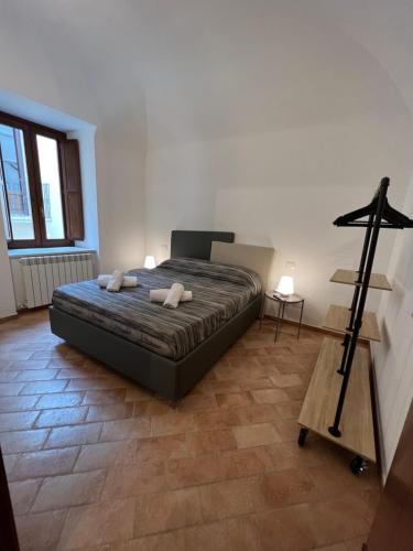 a bedroom with a bed with two pillows on it at IN MEDIA URBE - intero appartamento in LʼAquila