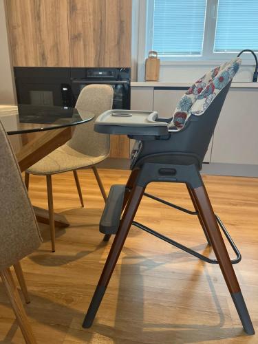 a high chair with a table and a laptop on it at Rezidencia pod Zámkom Bojnice Apartmán Luna in Bojnice