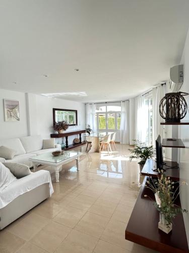 a living room with a couch and a table at Villa Teresa in Colonia Sant Jordi