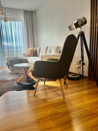 a living room with a couch and a chair at Rezidencia pod Zámkom Bojnice Apartmán Luna in Bojnice