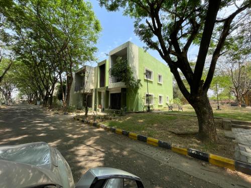 a green building on the side of a street at Samruddhi S3 homestay garden villa or S1 in Nagpur