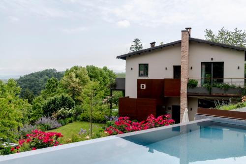 een huis met een zwembad en een tuin bij Villa Carla Suites in Barolo in Barolo