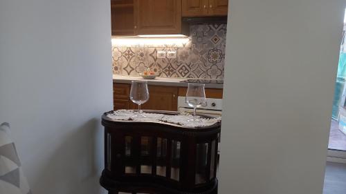 two wine glasses sitting on a table in a kitchen at Le Spiagge in Letojanni