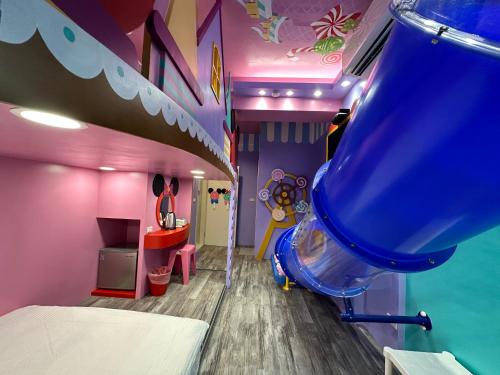 a childs room with a slide and a play room at Kaohsiung High Fun Hostel in Kaohsiung