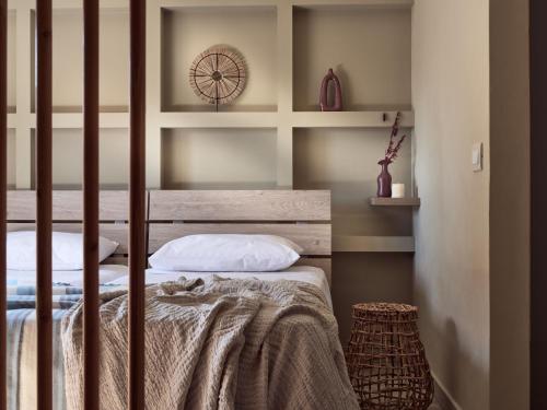 a bedroom with two beds and a clock on the wall at Laura Suites in Zakynthos Town