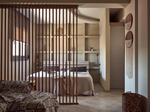 a bedroom with a bed with a iron gate at Laura Suites in Zakynthos Town