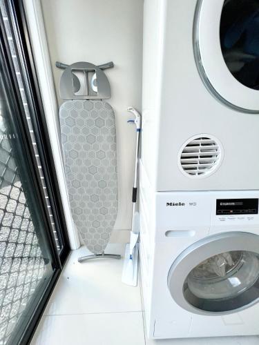 a washer and dryer in a washing machine at Plantation Retreat 4 Bedroom Modern Home in Landsborough