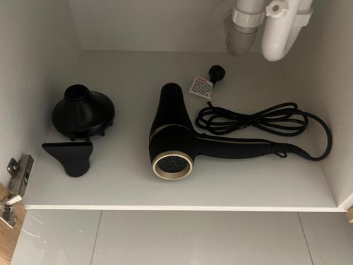 a white shelf with a keyboard and other items on it at Plantation Retreat 4 Bedroom Modern Home in Landsborough