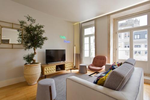 - un salon avec un canapé et une télévision dans l'établissement BOUTIQUE Rentals- P*O*R*T*O Ribeira, à Porto