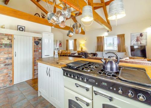 a kitchen with a stove with a tea kettle on it at Camper Uk Leisure Park in Doddington