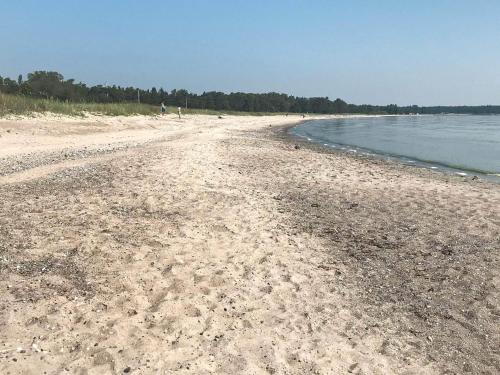a beach with a lot of sand and water at 6 person holiday home in Ljugarn-By Traum in Ljugarn