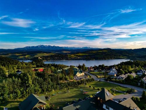an aerial view of a town with a lake and mountains at Eco Active Resort PIENINY in Czorsztyn