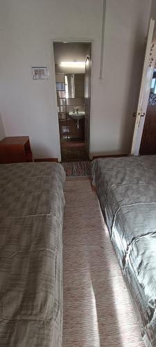 a hotel room with a bed and a bathroom at Zempléni Szellő Vendégház in Vilyvitány