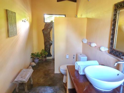 a bathroom with a sink and a toilet at Waiara Village Guesthouse in Maumere