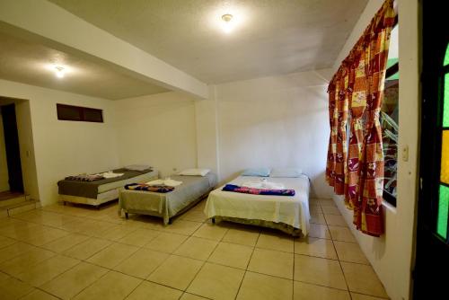 a room with two beds in a room at CASA EL ROBLE in San Juan La Laguna